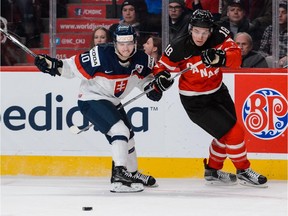 Jake Virtanen, seen battling Slovakia's Martin Reway during the World Juniors last year, is likely to be back with Team Canada again this Christmas unless he makes the Vancouver Canucks and they choose not to release him from NHL duty.