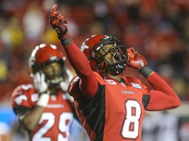 Calgary Stampeders defensive back Fred Bennett, centre, lets out a cheer after the Ottawa Redblacks field goal attempt is foiled by a kick into a post at McMahon Stadium in Calgary on Saturday, Aug. 15, 2015. The Calgary Stampeders won over the Ottawa Redblacks, 48-3, in regular season CFL play.