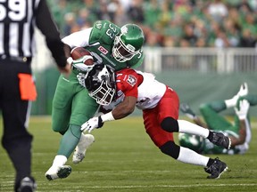 Saskatchewan Roughriders running back Jerome Messam is knocked out of bounds by Calgary Stampeders defensive back Joshua Bell on Saturday.