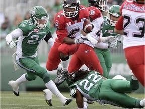 Calgary Stampeders running back Tim Brown jumps over the tackle of Saskatchewan Roughriders defensive back Don Unamba during last Saturday's game. The return man again found the endzone but the TD was called back on a penalty.