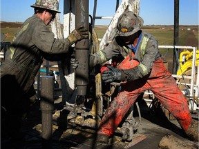 Crew work on a conventional drilling rig in Alberta.