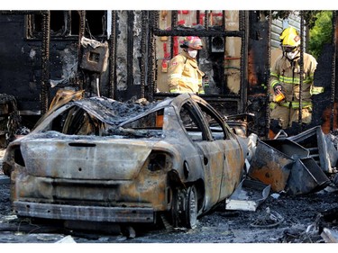 Firefighters investigate the scene of a house fire at Templevale Drive NE Calgary on August 13, 2015.