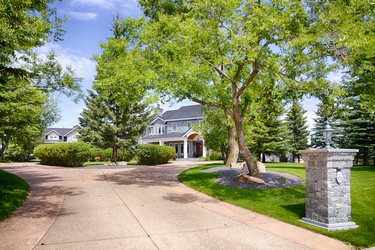 The property, listed at $12.25M, features an expansive driveway and a seven-car garage.