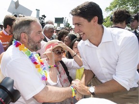 Liberal Leader Justin Trueau, right, greets NDP Leader Thomas Mulcair during a federal election campaign stop at the annual gay pride parade in Montreal on Aug. 16.