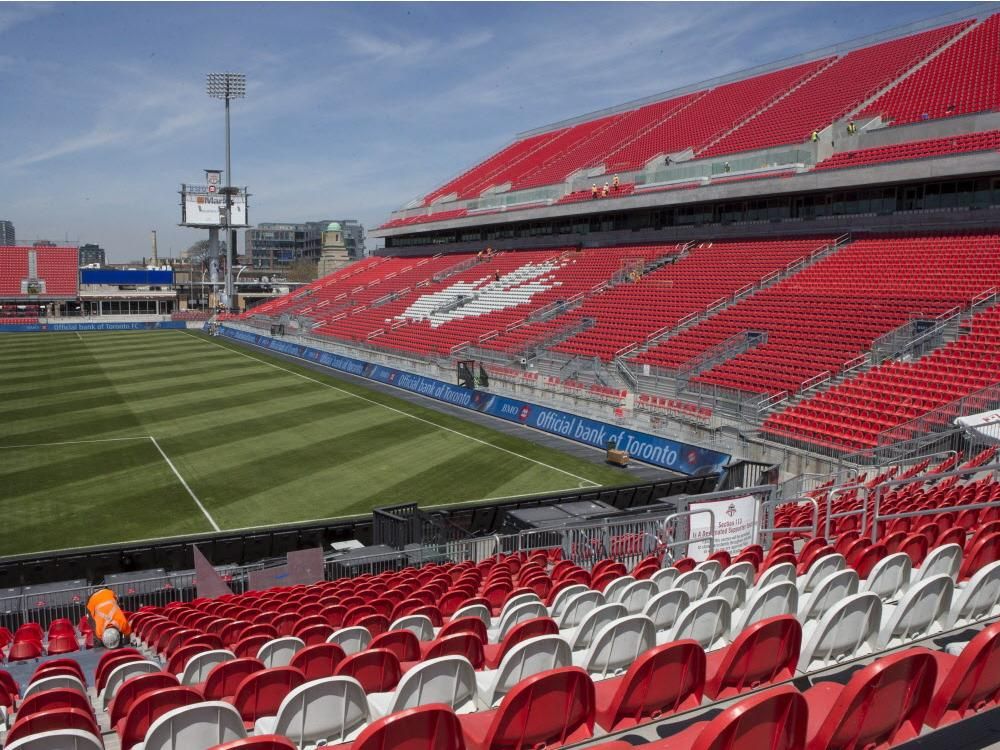 A worker fixes a seat at Toronto FC's BMO Field on Thursday, May 7, 2015, as work continues to ready the newly revamped stadium ahead of the Sunday home opener.
