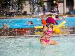 Kirsi Doucher, 5, enjoys some pool toys at Bowview Outdoor Pool in Calgary on Monday, Aug. 10, 2015