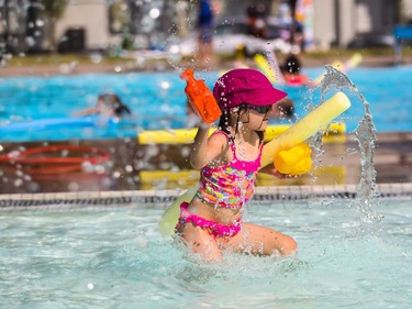 Kirsi Doucher, 5, enjoys some pool toys at Bowview Outdoor Pool in Calgary on Monday, Aug. 10, 2015.