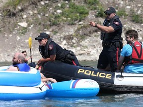 The Calgary Police Service's river patrol unit sweeps the Bow River near the Harry Boothman pedestrian bridge for rafters not wearing personal floatation devices and consuming alcohol or other illegal substances on Sunday afternoon near Edworthy Park.