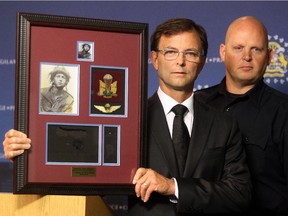 Calgary Police Service Acting Staff Sgt. Doug Crippen, right, and Pat Hartigan are asking for assistance from the public after Second World War medals presented to Hartigan's father were stolen from his Hawkwood home in July 2015.