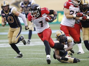Calgary Stampeders receiver Lemar Durant charges down the field, escaping the clutches of Winnipeg's Chris Randle during Saturday's game.