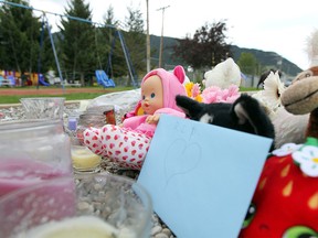 A memorial for Hailey Dunbar-Blanchette with candles, stuffed animals and flowers at a playground at Lion's Park.