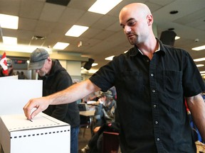 Adam Huebert casts his ballot in a mock election hosted by the Calgary Homeless Foundation at the Calgary Drop-In & Rehab Centre in Calgary on Monday, Sept. 21, 2015.