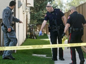 Police look for clues at a townhouse complex  in the 4500 block of 7th Avenue S.E. in Forest Lawn after reports of a shooting outside one of the units Monday morning, Sept. 21, 2015. Well known gangster Henry Nguyen was wounded in the shooting.