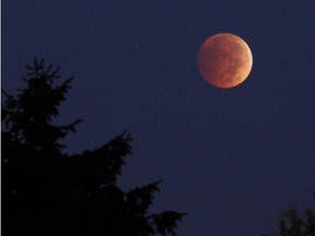 A lunar eclipse in Erie, Pa. on Oct. 8, 2014.  The moon appears orange or red, the result of sunlight scattering off Earth's atmosphere. This is known as the blood moon.