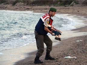 A police officer carries the lifeless body of Alan Kurdi, 3, after a number of migrants died and a smaller number were reported missing after boats carrying them to the Greek island of Kos capsized Wednesday. Reader says money being spent on the federal election campaign should be used instead to help the refugees.