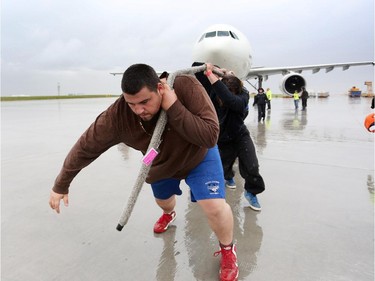 Josh Sauriol with Team Trident Tuggers helps pull  a 200,000 lb Airbus A300 with the rest of his team during the fourth annual Plane Pull event put on by United Way Calgary and Area at UPS in Calgary on September 13, 2015.