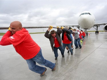 Team Vermilion Energy pull  a 200,000 lb Airbus A300 with the rest of his team during the fourth annual Plane Pull event put on by United Way Calgary and Area at UPS in Calgary on September 13, 2015.