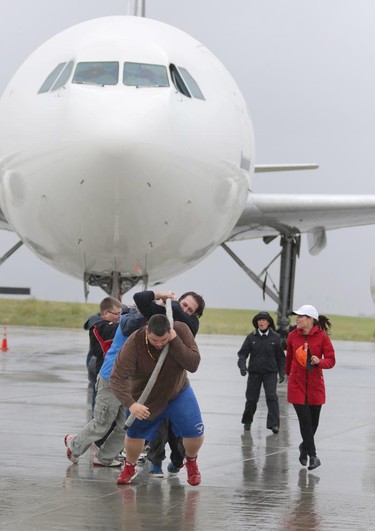 Josh Sauriol with Team Trident Tuggers helps pull  a 200,000 lb Airbus A300 with the rest of his team during the fourth annual Plane Pull event put on by United Way Calgary and Area at UPS in Calgary on September 13, 2015.