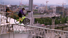 Brent Sweeney attempts to ride a bicycle across a plank suspended between two beams of B.C. Place in Vancouver during a challenge on The Amazing Race Canada season finale.