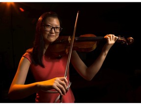 Angela Ryu, 16, champion violinist poses with her violin  in Calgary on Friday, Aug. 28, 2015. (Aryn Toombs/Calgary Herald)