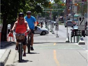 Cyclists ride the downtown cycle track.