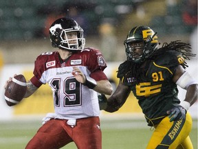 Calgary Stampeders quarterback Bo Levi Mitchell is chased down by Edmonton Eskimos Marcus Howard during Saturday's game.