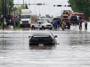 Cars become stuck at 12 Ave. and 3 St. S.E. in High River, Alberta Thursday, June 20, 2013. The town of High River was hit by massive flooding.