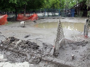 An animal enclosure at the Calgary Zoo is seen covered in mud on June 25, 2013, after the zoo received substantial flooding.