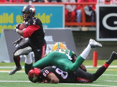 Running back Tim Brown looks for a route as WR Eric Rogers takes out Eskimos Willie Jefferson as the Calgary Stampeders played host to the Edmonton Eskimos for the Labour Day Classic on September 7, 2015 at McMahon Stadium.
