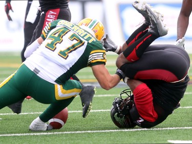 Stampeders Tim Brown loses the ball as he ends up on his head with Eskimos LB JC Sherritt looking to scoop it up as the Calgary Stampeders played host to the Edmonton Eskimos for the Labour Day Classic on September 7, 2015 at McMahon Stadium.
