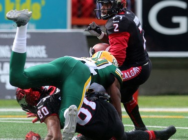Running back Tim Brown looks for a route as WR Eric Rogers takes out Eskimos Willie Jefferson as the Calgary Stampeders played host to the Edmonton Eskimos for the Labour Day Classic on September 7, 2015 at McMahon Stadium.