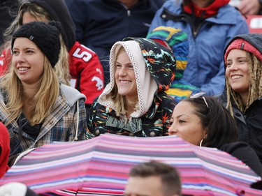 Football fans bundles up as showers moved through during second half Labour Day Classic action at McMahon Stadium on Monday September 7, 2015. Calgary won the game 16-7.
