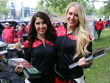 Cheerleaders Kendra, left, and Kaylea had lots of tailgating people to sell their calenders to as the fans arrived early to watch the Calgary Stampeders play host to the Edmonton Eskimos for the Labour Day Classic on September 7, 2015.