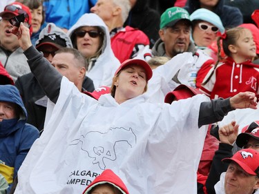A Calgary fan sings in the rain during second half Labour Day Classic action at McMahon Stadium on Monday September 7, 2015. Calgary won the game 16-7.