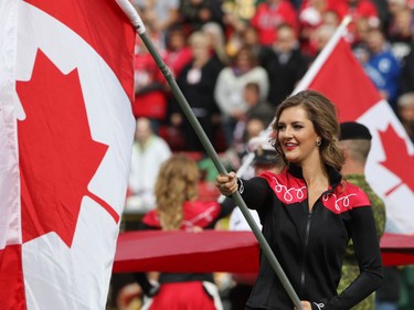 The Calgary Stampeder Outriders hold flags during the Labour Day Classic at McMahon Stadium on Monday September 7, 2015. Calgary won the game 16-7.