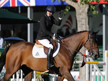 Canada's Tiffany Foster waves to the audience after competing during the $210,000 Tourmaline Oil Cup at the Spruce Meadows Masters on Friday September 11, 2015. Foster finished second in the event.