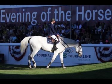 Peter Devos and Dylan from Belgium walk out of the ring in the evening light  after their ride during the $210,000 Tourmaline Oil Cup at the Spruce Meadows Masters on Friday September 11, 2015.
