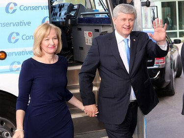 Conservative leader Stephen Harper and his wife Laureen Harper arrive and wave to the media at the BMO Centre in Calgary Thursday night.