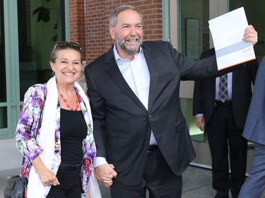 NDP Leader Tom Mulcair and his wife Catherine Pinhas arrive and wave to the media at the BMO Centre in Calgary Thursday night.