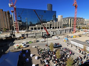 Representatives from the City of Calgary and the CMLC take part in the "topping off" ceremony of the extension of the LRT tunnel in the East Village. The completion of the tunnel allows construction of the new Central Library to begin.