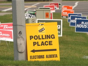 A garden of political signs outside the Foothills Alliance Church poll on the first day of advance polls for the Calgary-Foothills by-election Wednesday August 26, 2015.