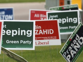 Political signs for the Calgary-Foothills byelection.