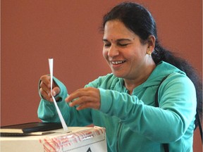 Sundari Karri casts her ballot last week at the Foothills Alliance Church during advance polls for the Calgary-Foothills byelection. Voters in the riding will head to the polls on Thursday, Sept. 3.