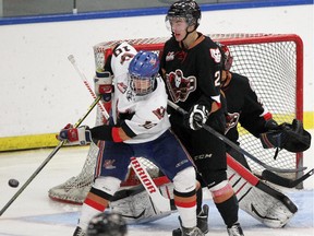 Calgary Hitmen defenceman Jake Bean, right, battles with hopeful  Bryce Platt during the team's intra-squad game on Tuesday. Bean had a goal and an assist against Regina on Thursday night.