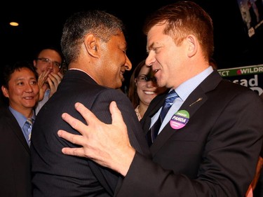 Wildrose Prasad Panda, left wins the Calgary Foothills by-election as he enters Crowfoot Boston Pizza with Wildrose Leader Brian Jean in Calgary on September 3, 2015.