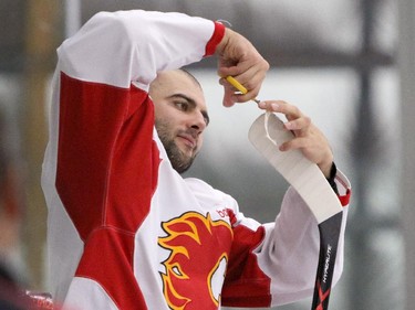 Defenceman Mark Giordano tapes his stick during Calgary Flames practice at Winsport ice Complex in Calgary on September 9, 2015.