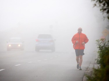 Michael Marchildon runs in the early morning fog in Calgary on September 10, 2015.