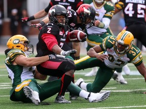 Stampeders returner Tim Brown is brought down by Eskimos Mathieu Boulay, 77, and Otha Foster during Monday's Labour Day Classic. He hurt his leg and will not play in the rematch, set for Saturday in Edmonton.