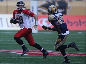 Calgary Stampeders QB Bo Levi Mitchell is pressured by Winnipeg Blue Bombers DB Bruce Johnson during CFL action at Investors Group Field in Winnipeg on Sat., Aug. 29, 2015.