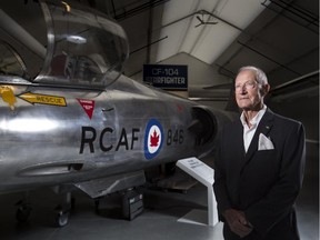 Retired major-general Ken Lett stands with a CF-104 Starfighter — a plane he piloted during the Cold War — at an exhibit at the Military Museums marking the four-decade conflict.